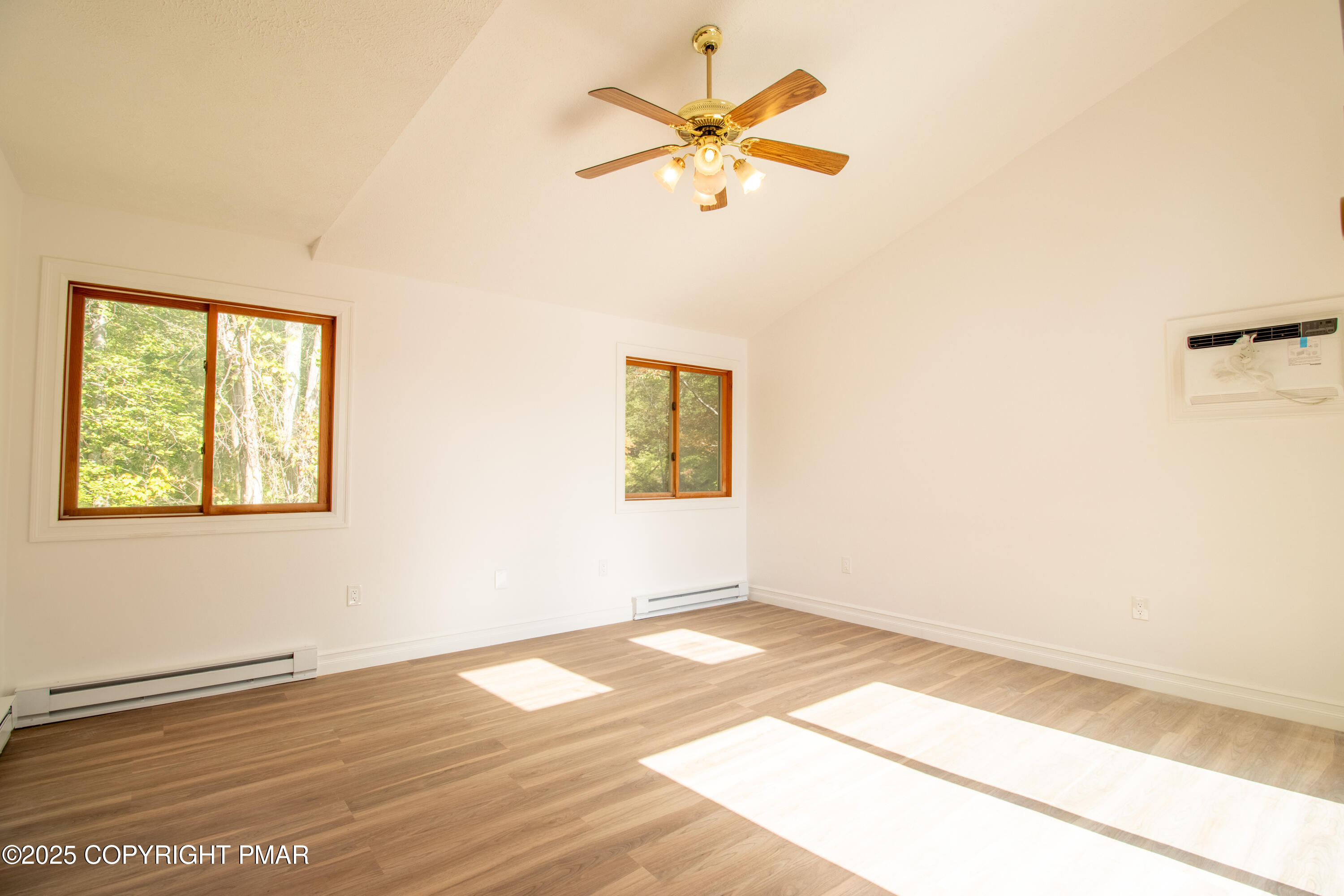 1142 Yorkshire Lane Bushkill, PA 18324 - Photo 24 of 72 an empty room with wooden floor fan and windows
