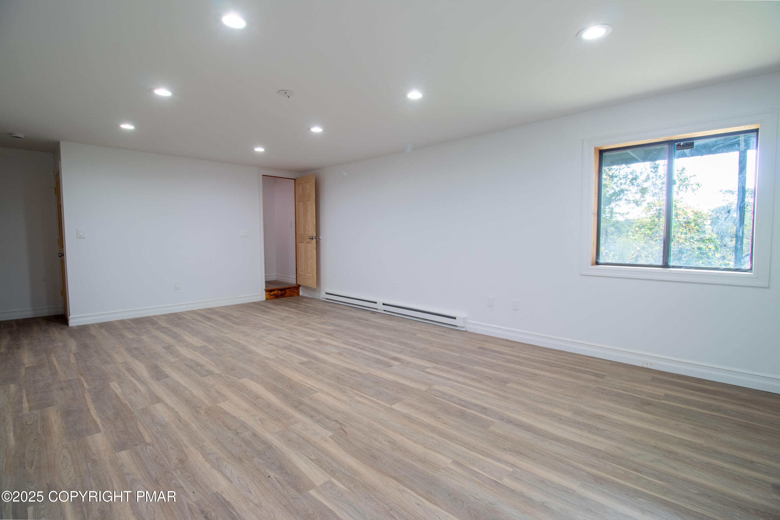 1142 Yorkshire Lane Bushkill, PA 18324 - Photo 34 of 72 an empty room with wooden floor and windows