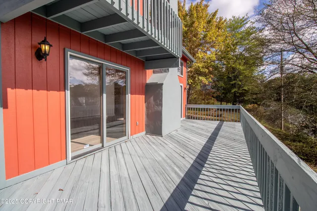 a view of a lake in between two large trees