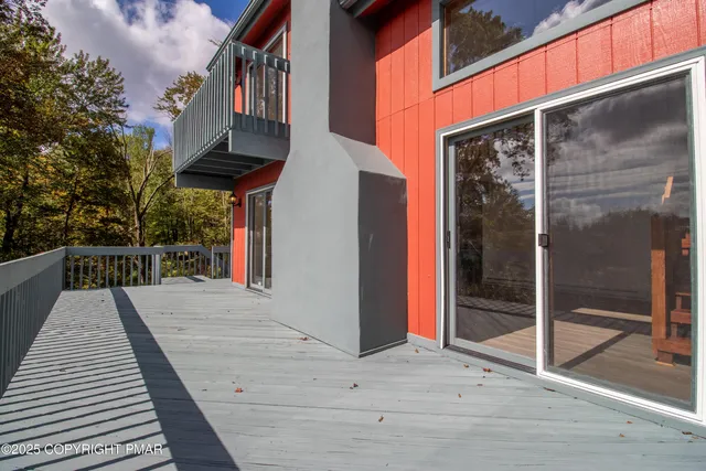 a view of a swimming pool with lawn chairs under an umbrella