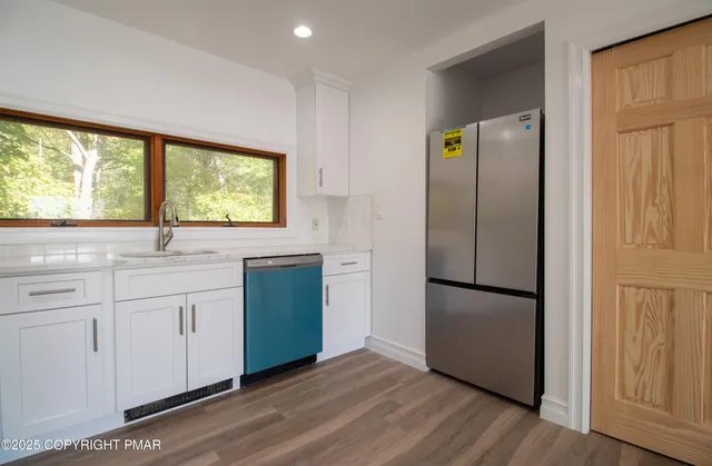 a dining room with furniture a fireplace and a large window