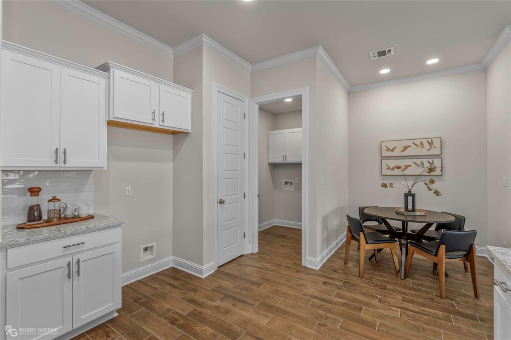 316 Peason Ridge Bossier City, LA 71112 - Photo 12 of 36 a workspace with wooden floor and cabinets