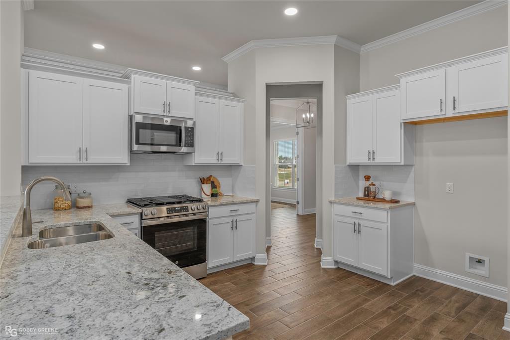 316 Peason Ridge Bossier City, LA 71112 - Photo 10 of 36 a kitchen with sink a stove and cabinets
