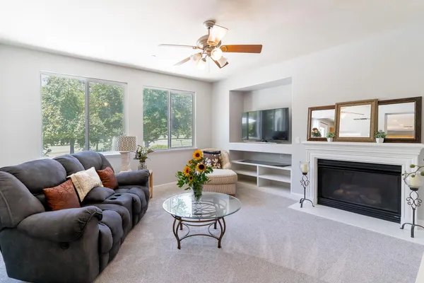 a living room with furniture a fireplace and a flat screen tv