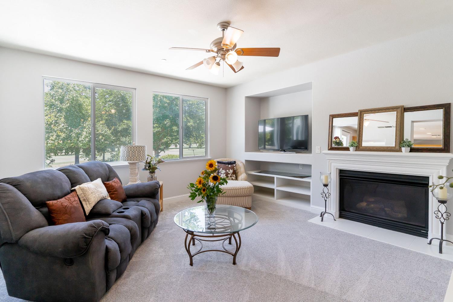 34676 Canvas Back Street Woodland, CA 95695 - Photo 16 of 28 a living room with furniture a fireplace and a flat screen tv