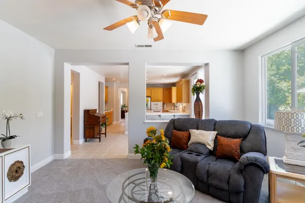 a living room with furniture a chandelier and a window