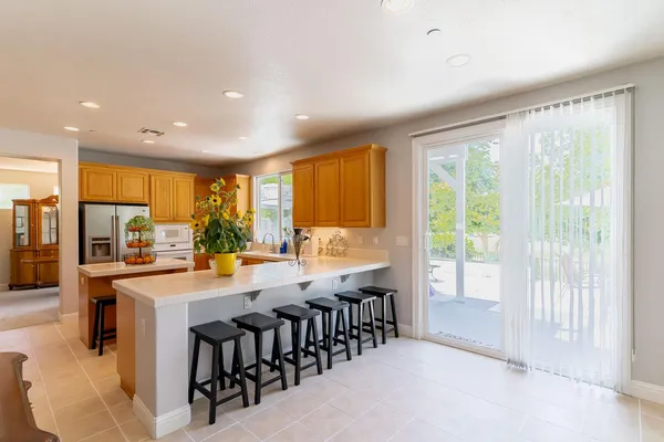 a large kitchen with lots of counter space and glass windows