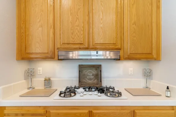 a kitchen with a sink cabinets and a wooden floor