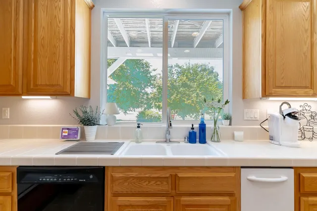 a kitchen with a sink and a large window
