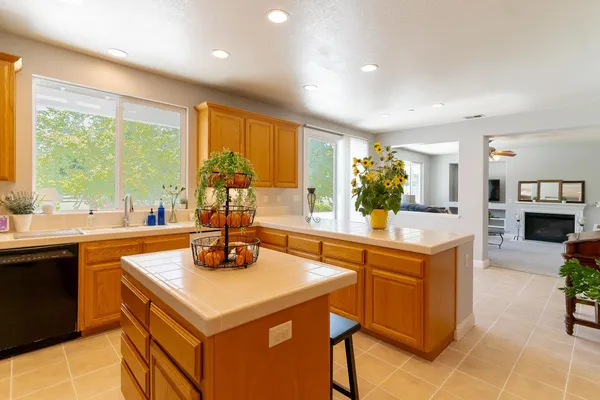 a kitchen with stainless steel appliances granite countertop a sink a stove and a refrigerator