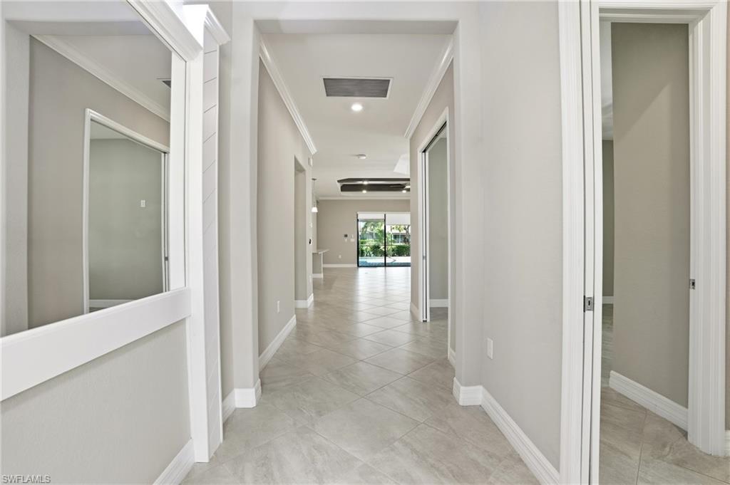 28076 Foxrock Court Bonita Springs, FL 34135 - Photo 8 of 50 Corridor with light tile patterned floors, recessed lighting, crown molding, ornamental entry molding w/ mirror.