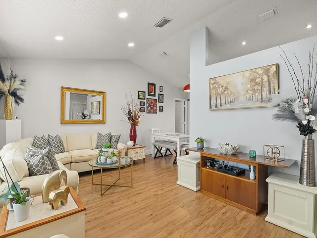 a living room with furniture and wooden floor