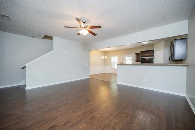 a view of a kitchen with a dishwasher a kitchen wooden floor and a window