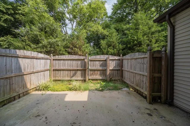 a backyard of a house with wooden fence