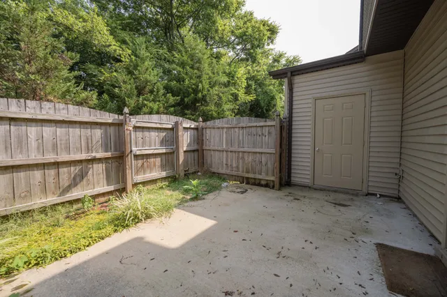 a front view of a house with a yard and plants