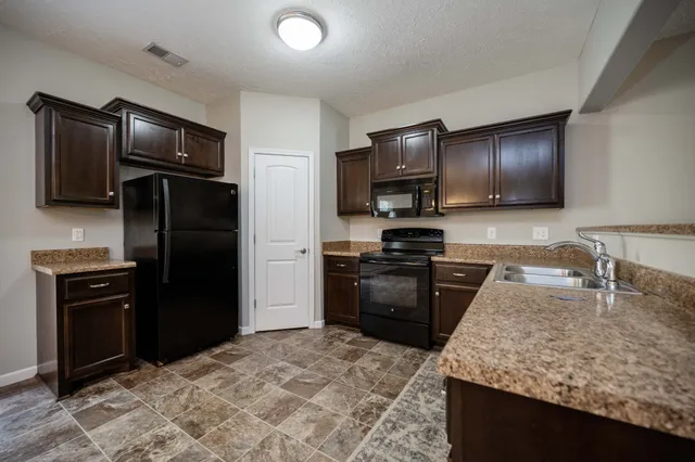a kitchen with a refrigerator stove and refrigerator