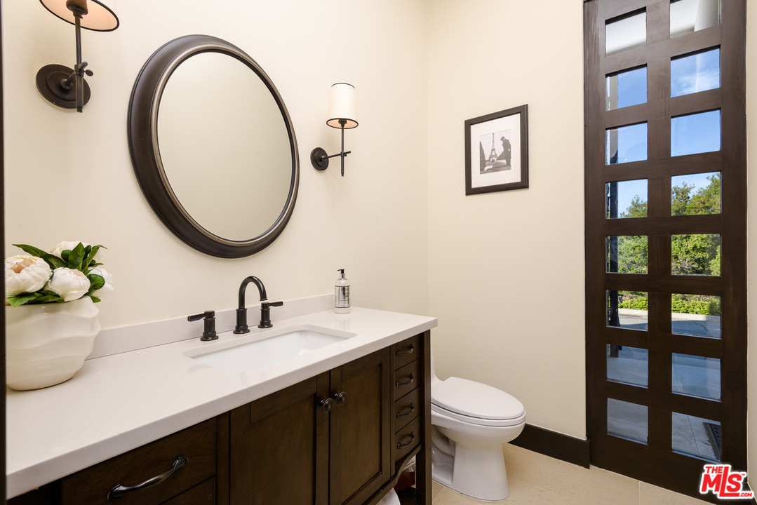 2175 Summitridge Drive Beverly Hills, CA 90210 - Photo 22 of 51 a bathroom with a sink and a mirror