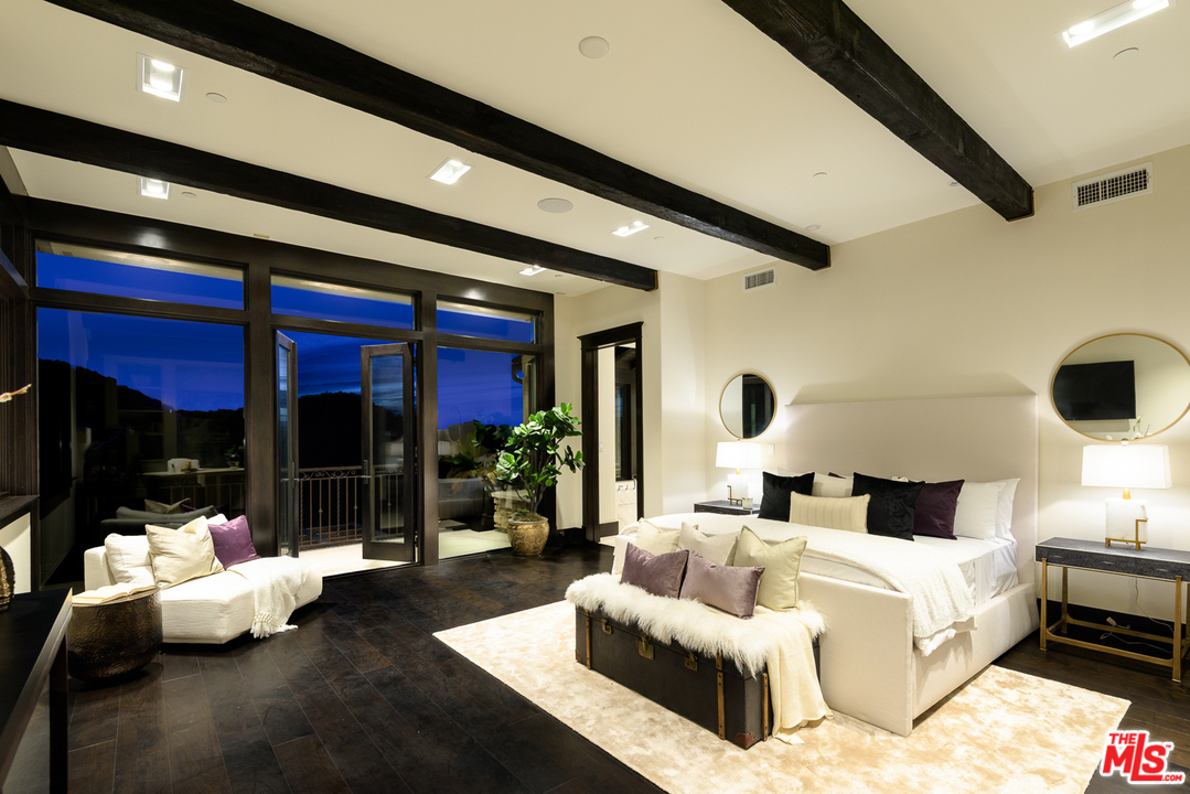 2175 Summitridge Drive Beverly Hills, CA 90210 - Photo 25 of 51 a bedroom with a large bed and a large window