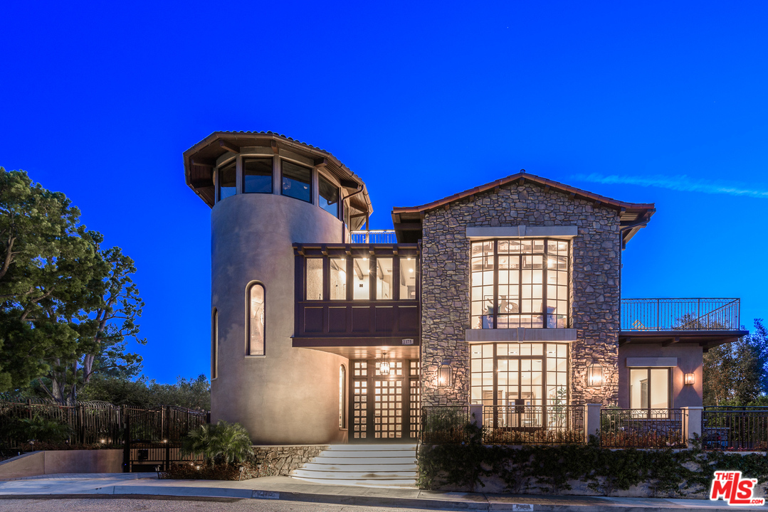 2175 Summitridge Drive Beverly Hills, CA 90210 - Photo 3 of 51 a front view of a house with a yard