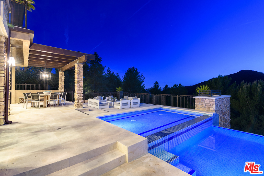 2175 Summitridge Drive Beverly Hills, CA 90210 - Photo 45 of 51 a view of a swimming pool with outdoor seating and city view