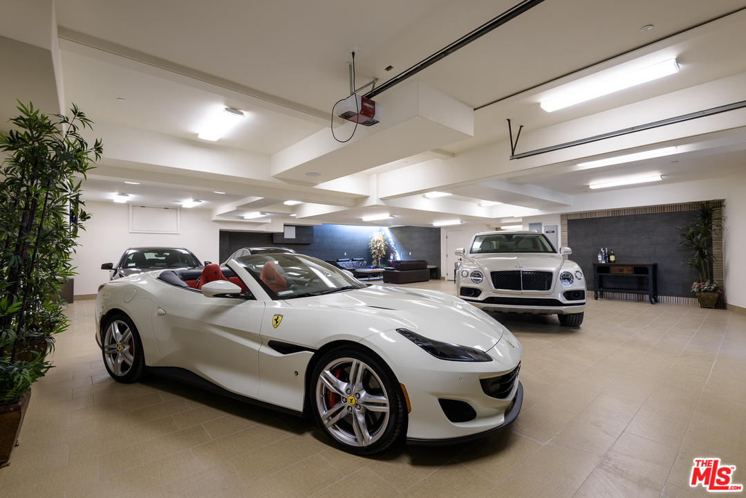 2175 Summitridge Drive Beverly Hills, CA 90210 - Photo 48 of 51 a car and car parked in a garage