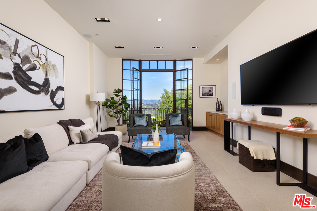 2175 Summitridge Drive Beverly Hills, CA 90210 - Photo 6 of 51 a living room with furniture and a flat screen tv