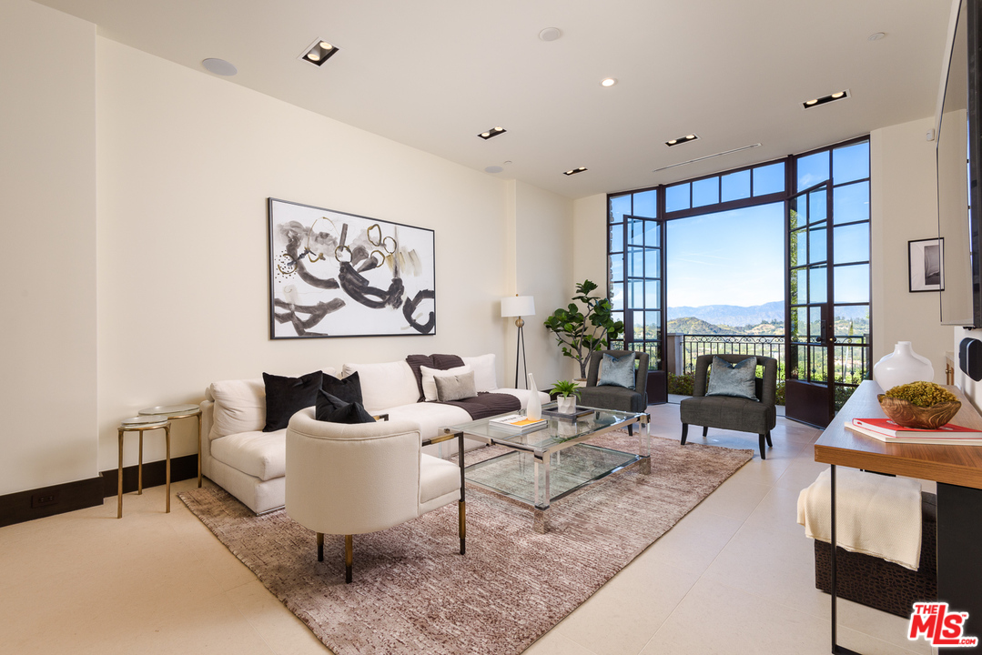 2175 Summitridge Drive Beverly Hills, CA 90210 - Photo 8 of 51 a living room with furniture and a large window