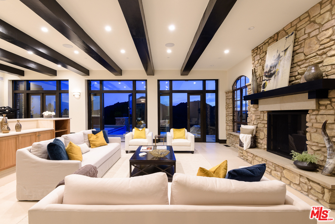 2175 Summitridge Drive Beverly Hills, CA 90210 - Photo 9 of 51 a living room with furniture and a fireplace