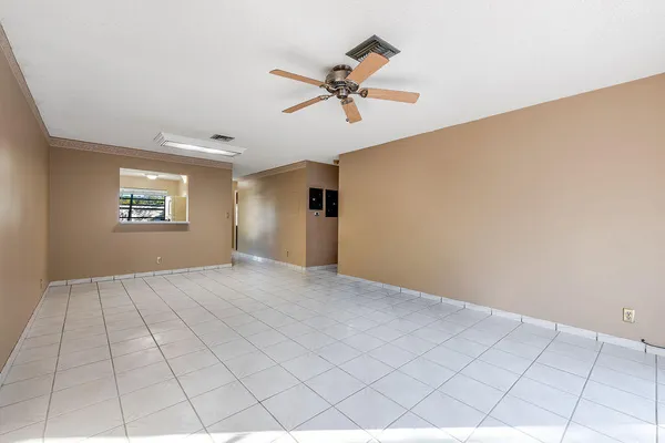 a view of a livingroom with a ceiling fan and window