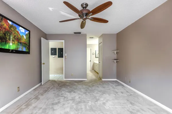 en empty room with window and a ceiling fan