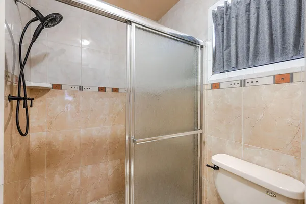 a bathroom with a shower and toilet