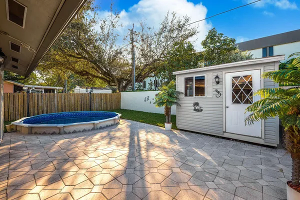a view of a backyard with a large tree