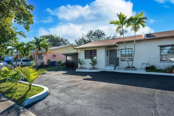 a front view of house with a garden