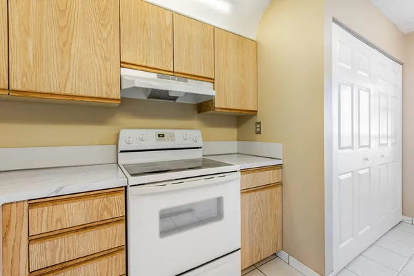 a stove top oven sitting inside of a kitchen
