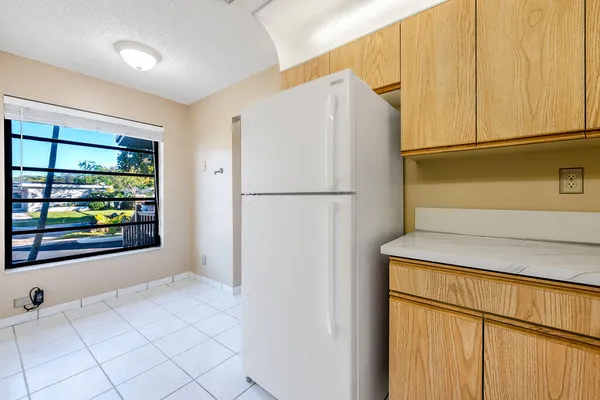 a white refrigerator freezer sitting in a kitchen