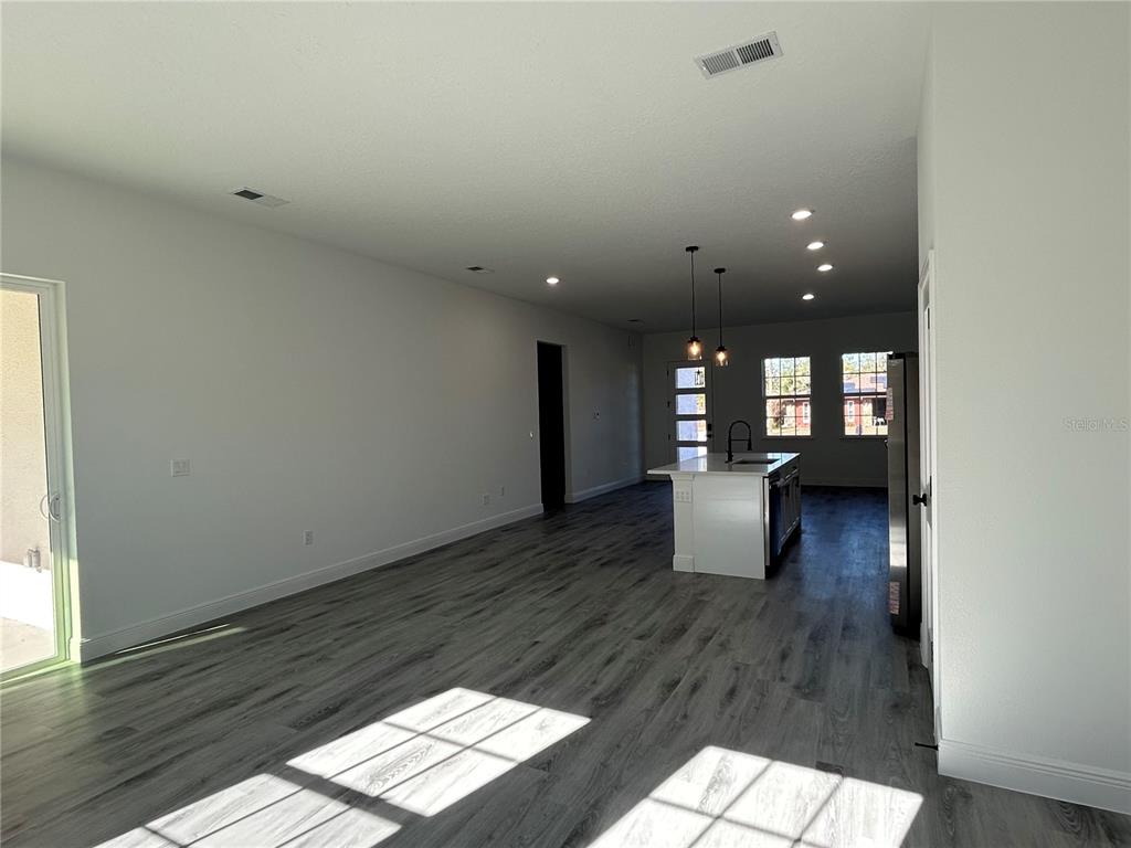 555 Marion Oaks Golf Road Ocala, FL 34473 - Photo 14 of 34 a view of wooden floor and windows in a room