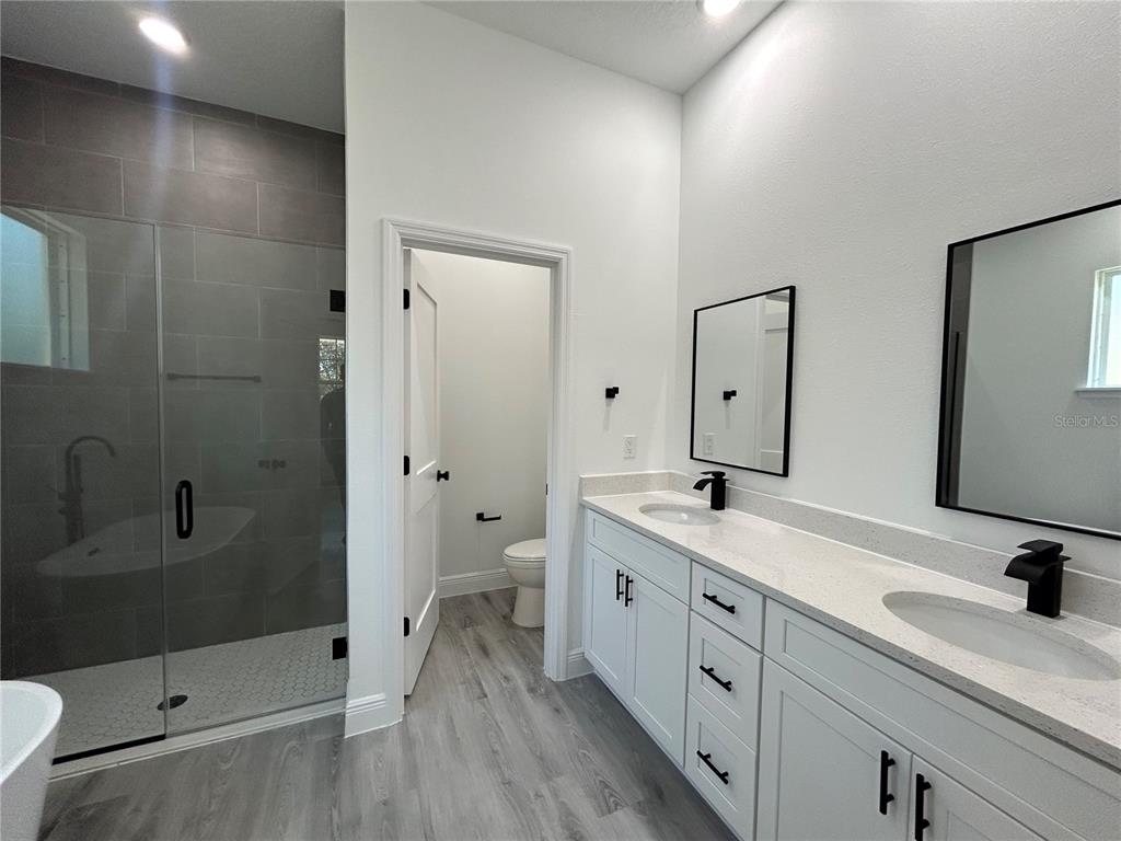 555 Marion Oaks Golf Road Ocala, FL 34473 - Photo 18 of 34 a spacious bathroom with a shower sink and mirror