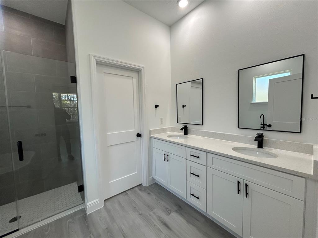555 Marion Oaks Golf Road Ocala, FL 34473 - Photo 20 of 34 a bathroom with a double vanity sink and mirror