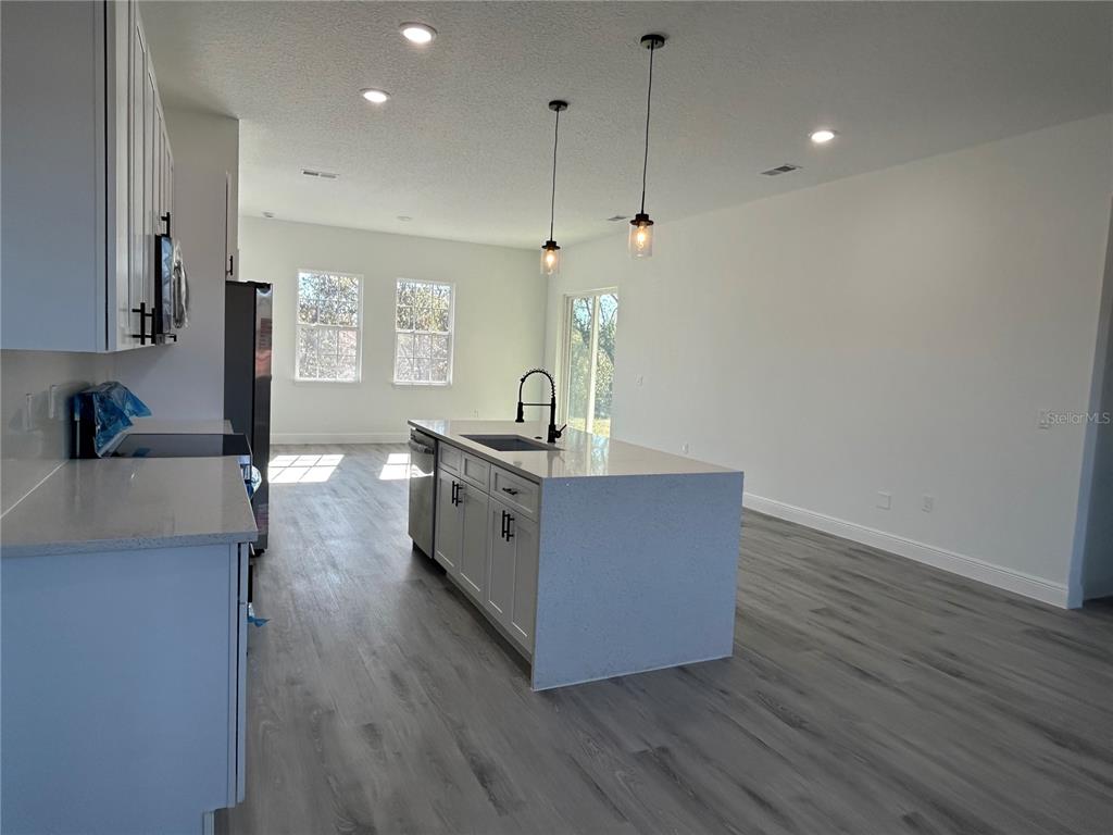 555 Marion Oaks Golf Road Ocala, FL 34473 - Photo 10 of 34 a living room with stainless steel appliances furniture a refrigerator a sink and wooden floor