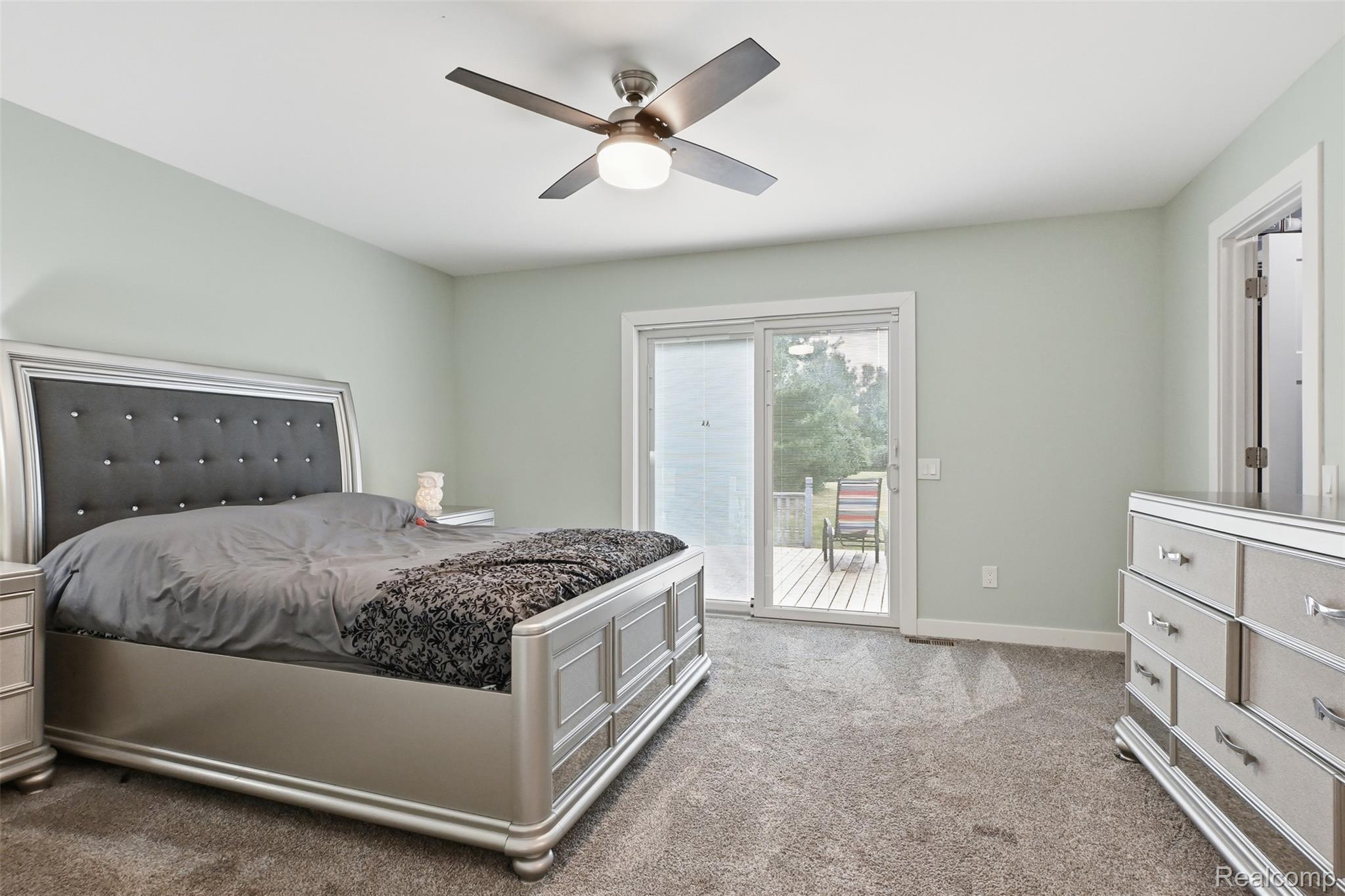 45738 Bemis Road Belleville, MI 48111 - Photo 32 of 52 Light-colored walls and grey carpeting complement a ceiling fan with integrated lighting