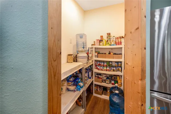 a close view of a sink and dishwasher with kitchen island