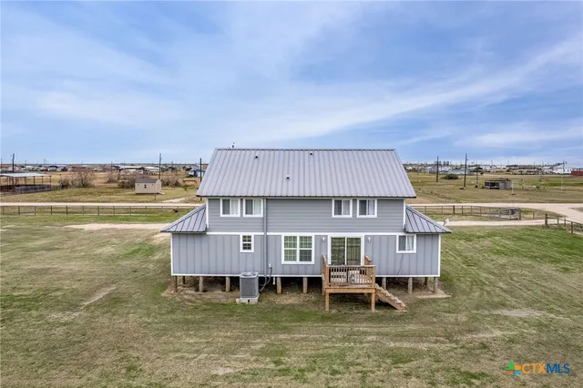 a view of a lake with a big yard and large trees