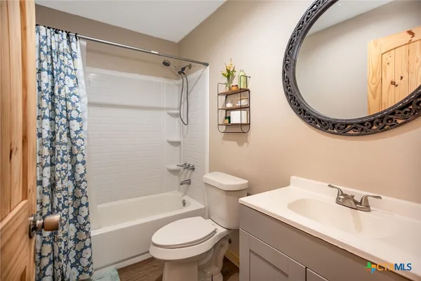 a spacious bedroom with a bed and a dresser