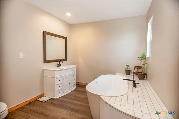 a white tub sitting in a bathroom