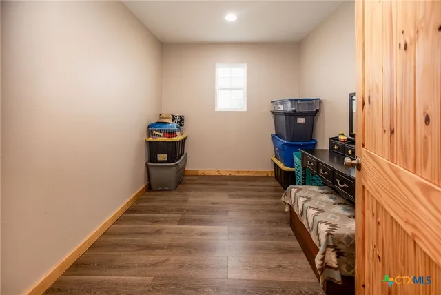 a bedroom with a large bed and a dresser