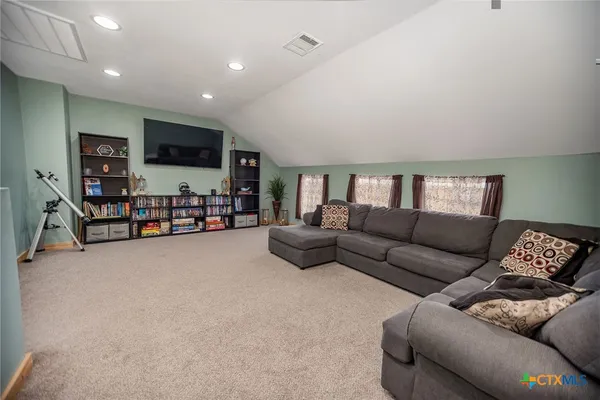 a spacious bedroom with a bed and a window