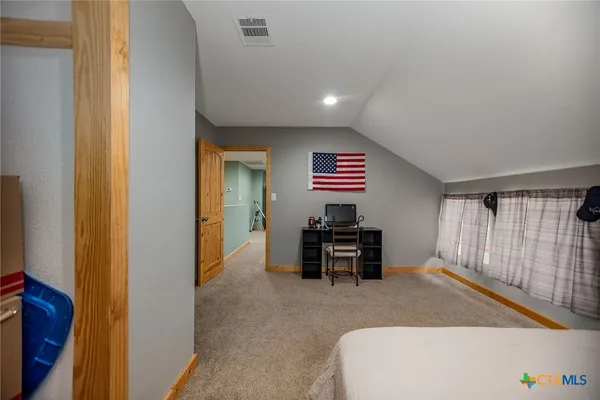 a bedroom with a bed and a chair