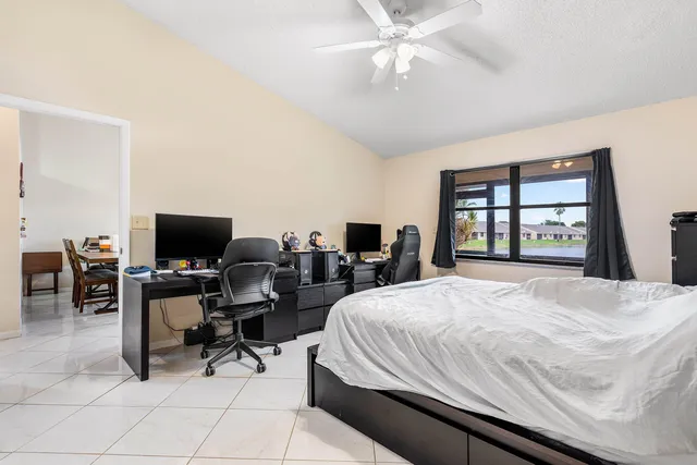 a bedroom with a bed and a large window
