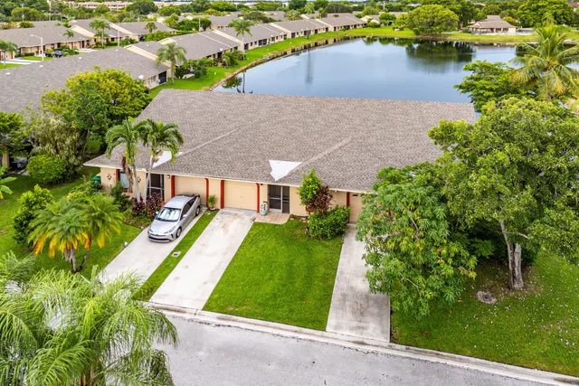 an aerial view of a house with outdoor space and lake view