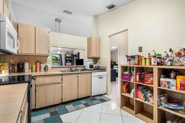 a kitchen with refrigerator and cabinets